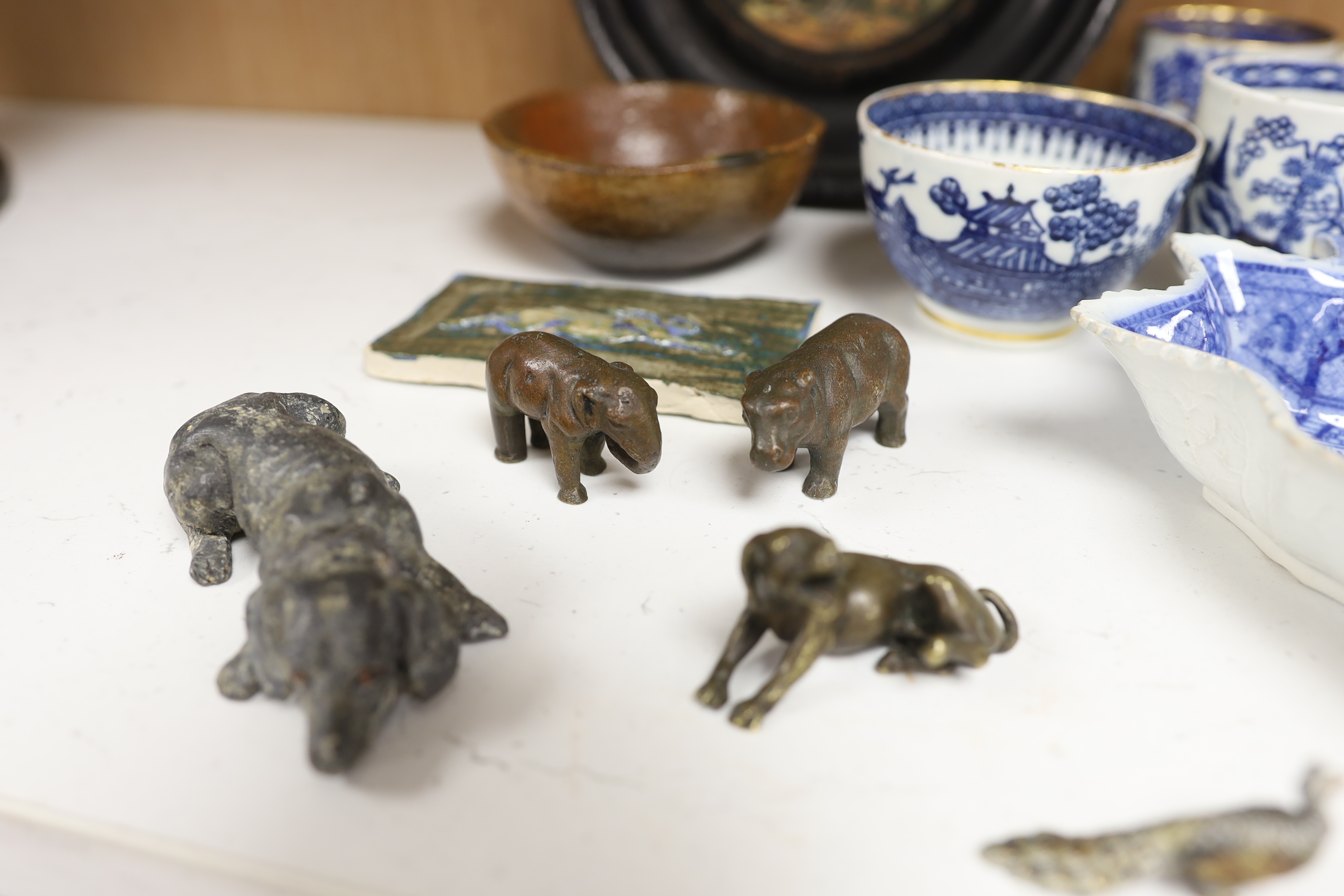 An early 20th century Viennese cold painted bronze figure of an African grey parrot, two 18th century English coffee cups, a leaf shape pickle dish, Victorian pot lid, other metal animal figures, a Japanese small carved